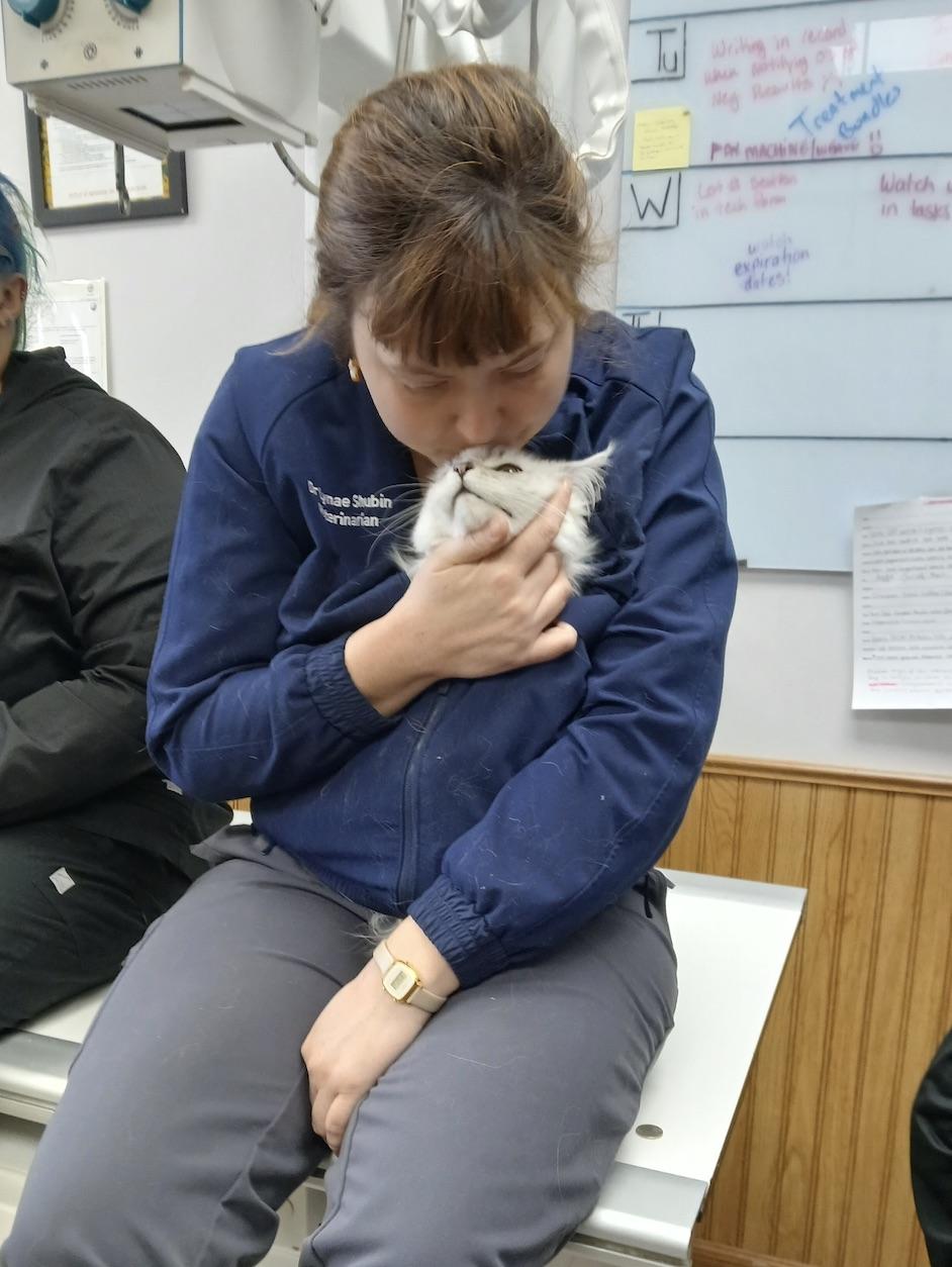 Cat tucked into woman's coat